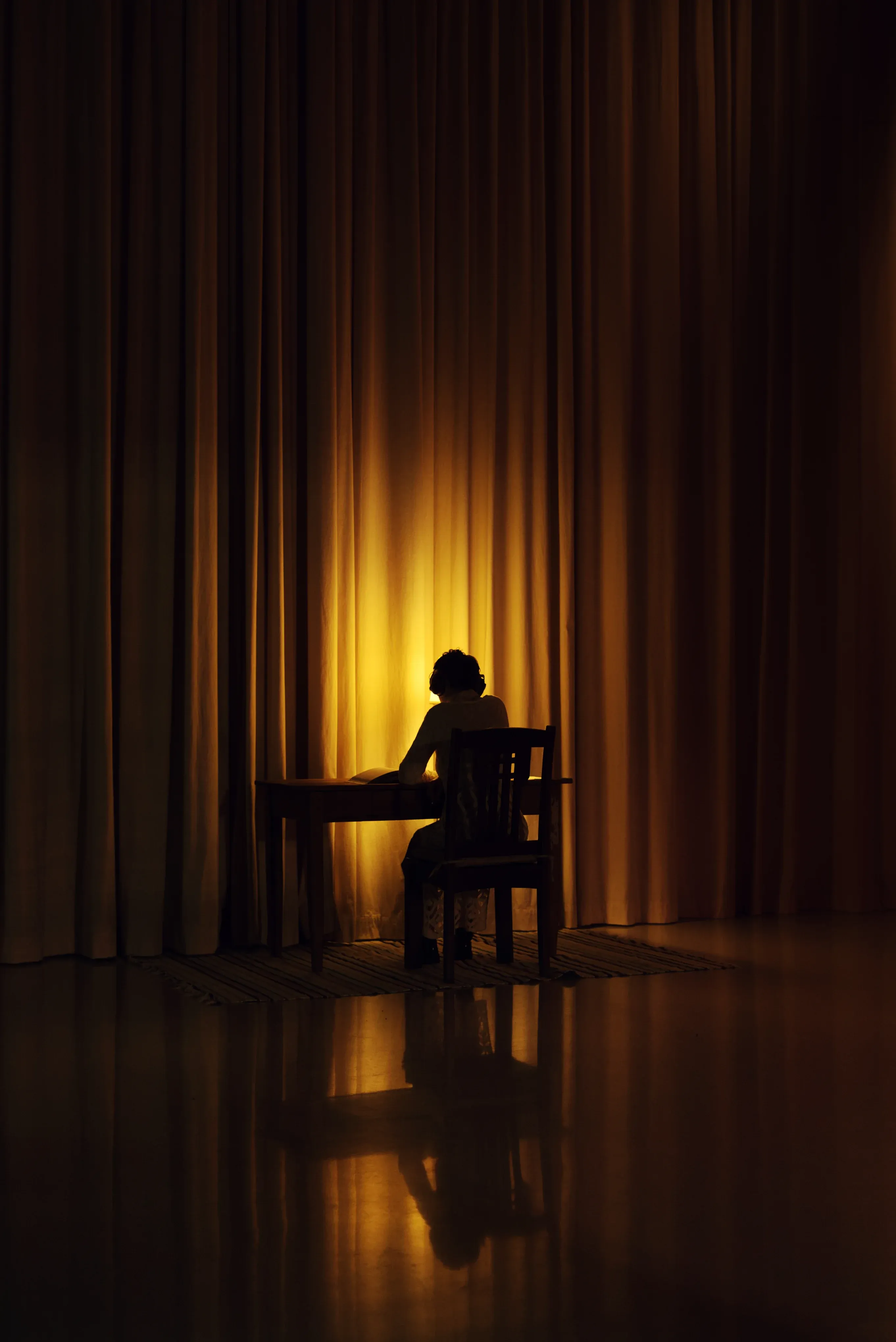 A person sitting at a warmly lit table.