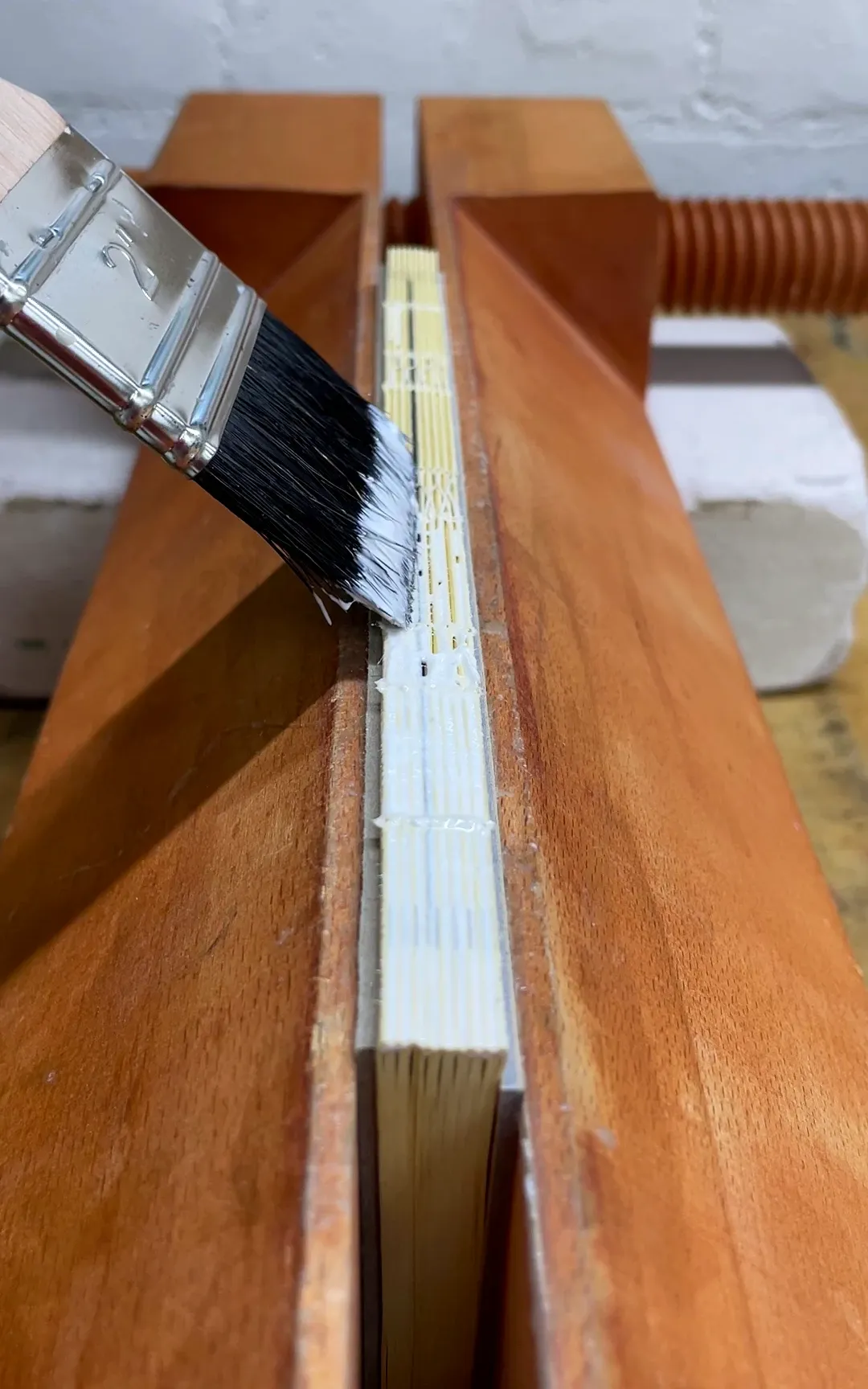 Gluing the back of the book.