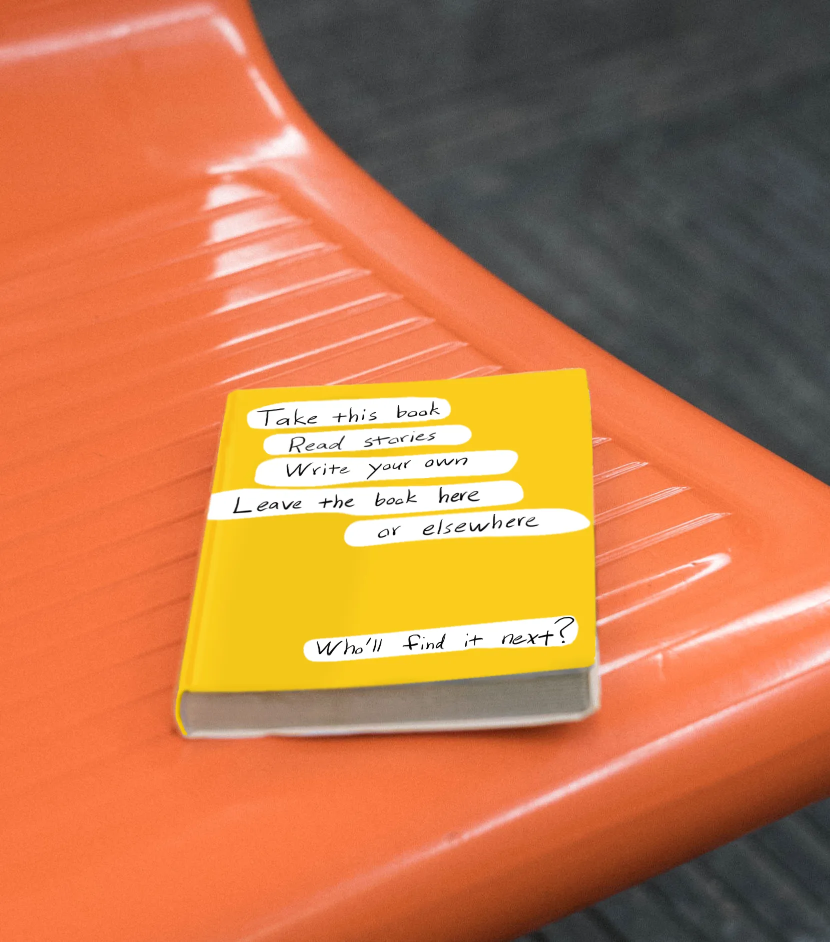 A yellow book lying on a bench.